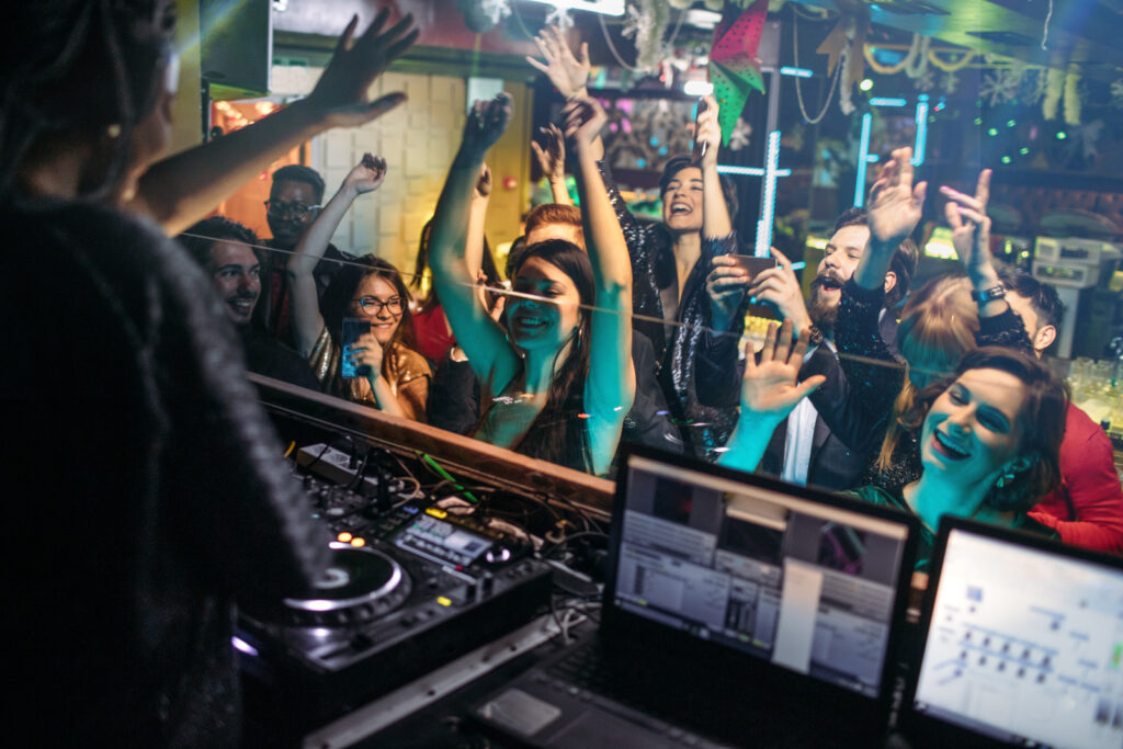 Group of young people dancing at the party in the nightclub.