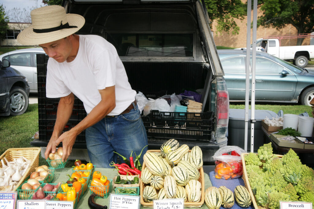 Farmer selling Organic produce at local community Farmer's Market