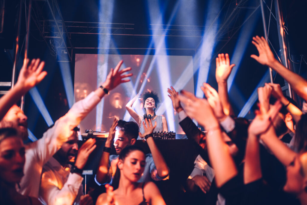 Female DJ playing music at a nightclub