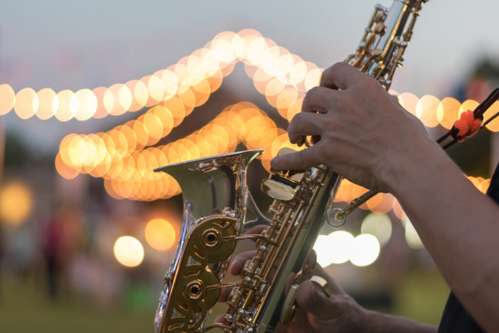 Saxophone, music instrument played by saxophonist player musician in fest.